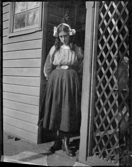 Stella standing at doorway, Yathella, New South Wales, ca. 1912 [picture] / Abraham Valentine Booth