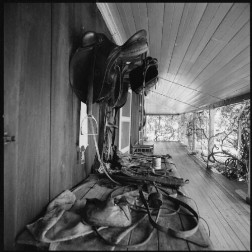 Riding gear on verandah of Mundoolun Homestead, Beaudesert, Queensland, ca. 1970 [picture] / Wes Stacey