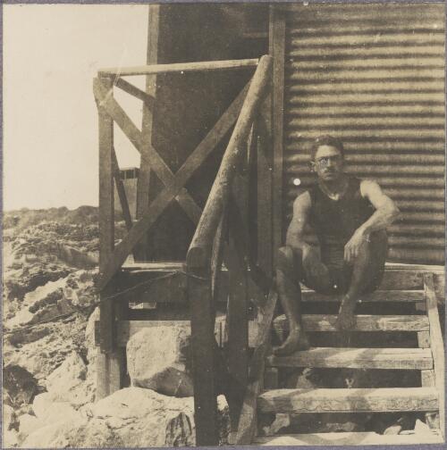 Karl Lehmann wearing a swimming costume, seated on steps at the beach, Rottnest Island, Western Australia, ca. 1915 [picture]