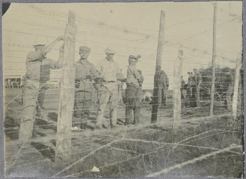 Internee workers securing barbed wire to a fence post, Holsworthy internment camp, New South Wales, ca.1917 [picture]