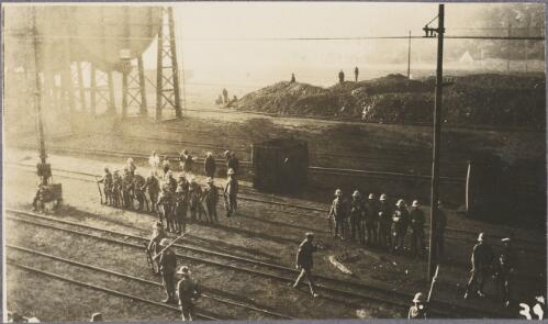 Military guards lined up next to the railway tracks on a pier, Durban?, South Africa, ca.1917 [picture] / Karl Lehmann