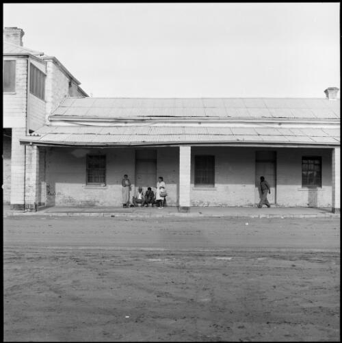 People under verandah of Club House Hotel, Wilcannia, New South Wales, ca. 1970 [picture] / Wes Stacey