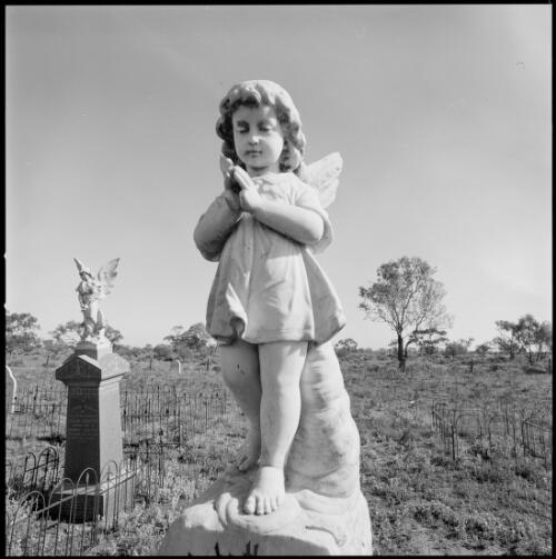 Statue of a child angel on a grave, Wilcannia Cemetery, Wilcannia, New South Wales, ca. 1970 [picture] / Wes Stacey