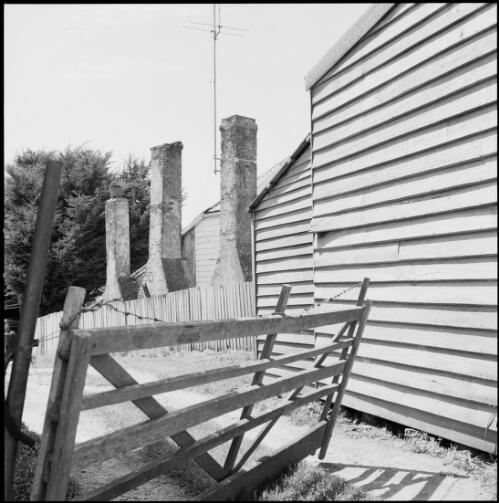 Gate at a laneway lined with weatherboard cottages, Oatlands, Tasmania, ca. 1970 [picture] / Wes Stacey