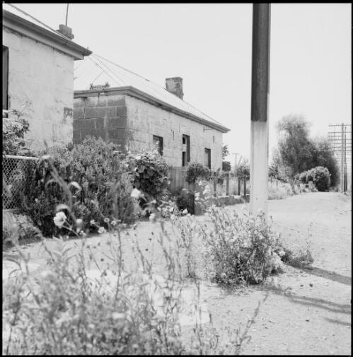 Footpath beside disused Georgian style cottages, Oatlands, Tasmania, ca. 1970 [picture] / Wes Stacey