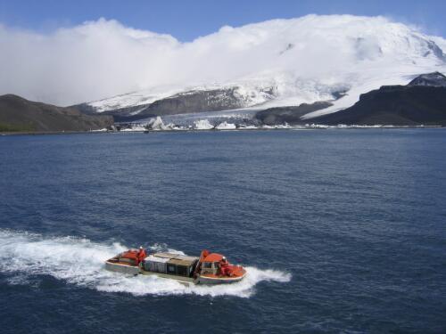 Light amphibious resupply cargo vessel transporting gear with Stephenson Glacier in background, Heard Island, Antarctica, February 2004 [picture] / Doug Thost