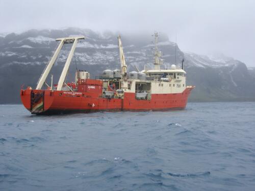 Research ship Southern Supporter carrying poly water tanks, and view of Laurens Peninsula in the background, near Atlas Cove, Heard Island, Antarctica, December 2003 [picture] / Doug Thost
