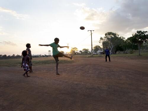 Aboriginal children playing football, Wudikapildiyerr outstation, Daly River, Northern Territory, 25 June 2010 [picture] / Darren Clark