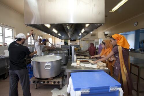 Members of the Sikh community preparing food for the Sikh congregation at the Sikh Centre, Glenwood, New South Wales, 2010 [picture] / Louise Whelan