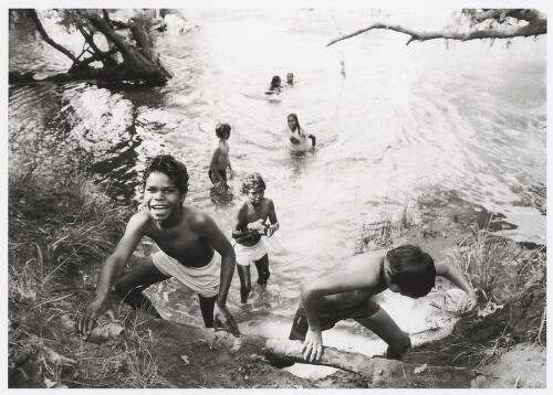 Aboriginal children playing in a creek, Cherbourg, Queensland, 1988 / Robert McFarlane
