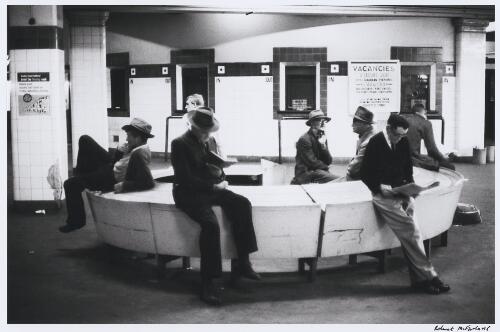Unemployed men waiting for the morning newspaper at a railway station, Sydney, New South Wales, approximately 1965 / Robert McFarlane