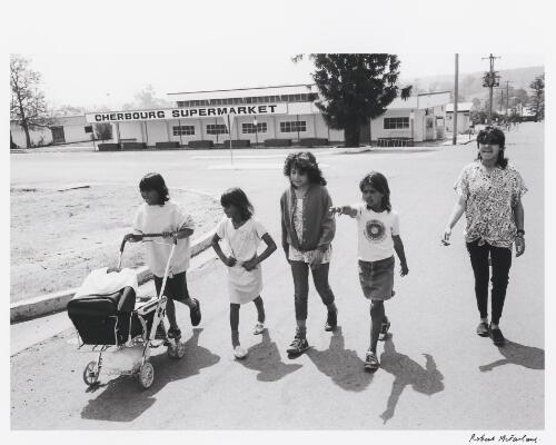 Group of young Aboriginal Australian girls walking along a street, Cherbourg, Queensland, 1986 / Robert McFarlane