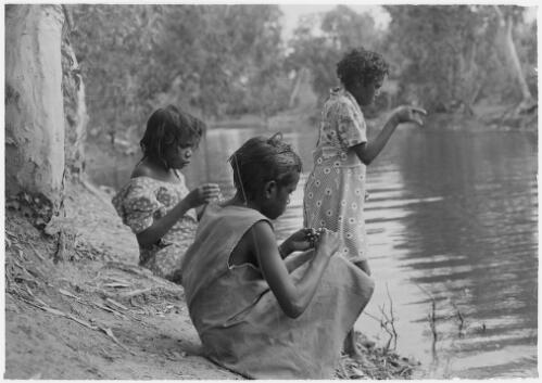 Three girls fishing for turtles at a water hole, Mornington Island, Queensland, approximately 1980 / Gregory Owen