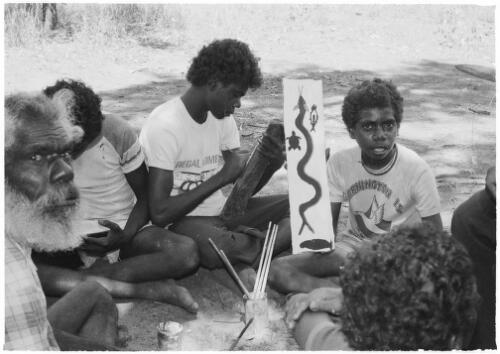 Teenage boy holding up his completed bark painting, Mornington Island, Queensland, approximately 1980 / Gregory Owen