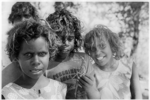 Three children with a stick insect, Mornington Island, Queensland, approximately 1980 / Gregory Owen