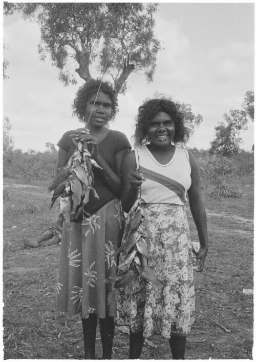 Two teenage girls holding their catch of fish, Mornington Island, Queensland, approximately 1980 / Gregory Owen