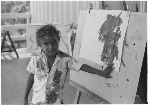 Boy with a painting on an easel, Mornington Island, Queensland, approximately 1980 / Gregory Owen