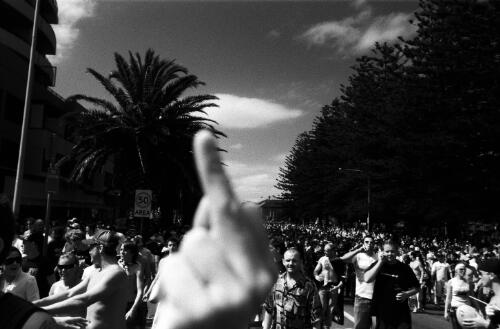 Rioters march down Elouera Road, Cronulla during the race riots in Cronulla, 11 December 2005 [picture] / Andrew Quilty
