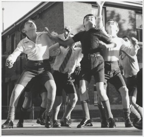 Schoolboys reaching for the ball, in the Paddle Shoes commercial, Melbourne, ca. 1965 [picture] / Maggie Diaz