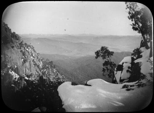 Cliff face as seen from a snow covered cliff edge, Victoria, approximately 1920 / Robert Wilkinson