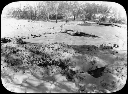 A creek in a snow covered clearing, Victoria, approximately 1920 / Robert Wilkinson
