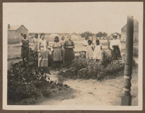 Aboriginal children and staff members in the garden at Koonibba Children's Home, South Australia