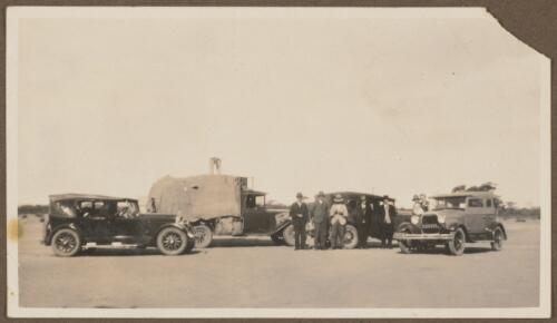 Seven men standing near three cars and a truck, Koonibba Mission Station, South Australia, 1930