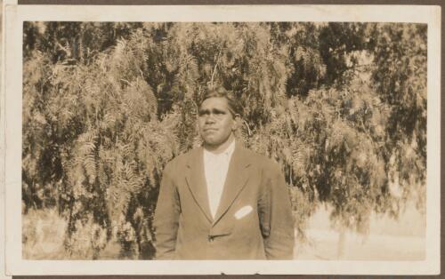 Aboriginal man standing in front of bushes, Koonibba Mission Station, South Australia
