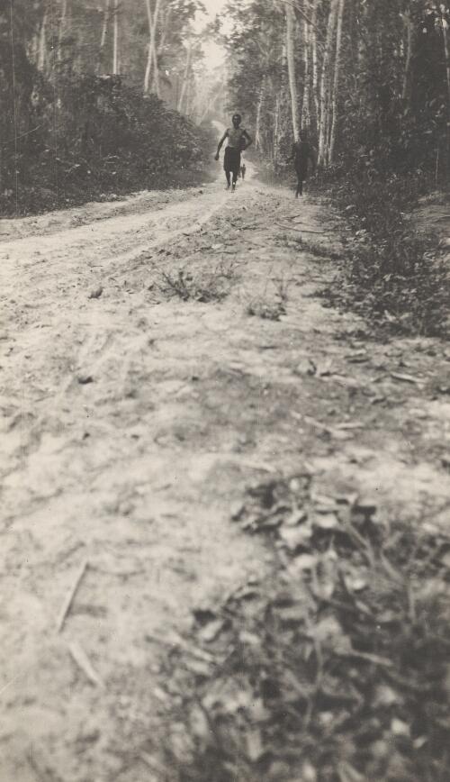 Two men walking along the Bita Paka road between Kabakaul and Bita Paka, German New Guinea, 1914