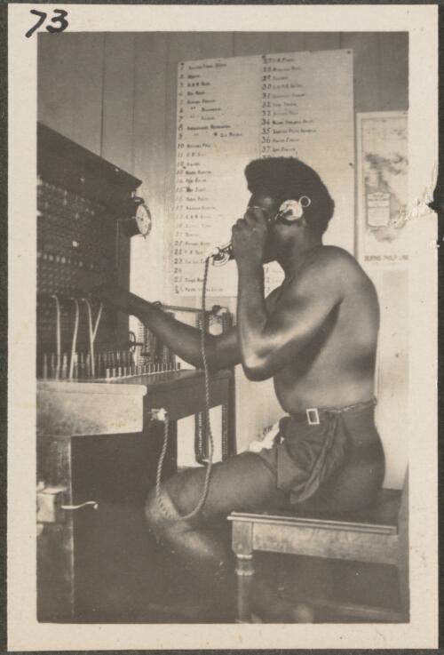 Papuan man at telephone switchboard at Rabaul Post Office, New Britain Island, Papua New Guinea, approximately 1916