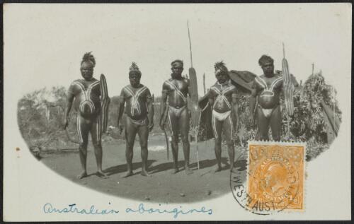 Group of Aboriginal men with tribal body markings and spears