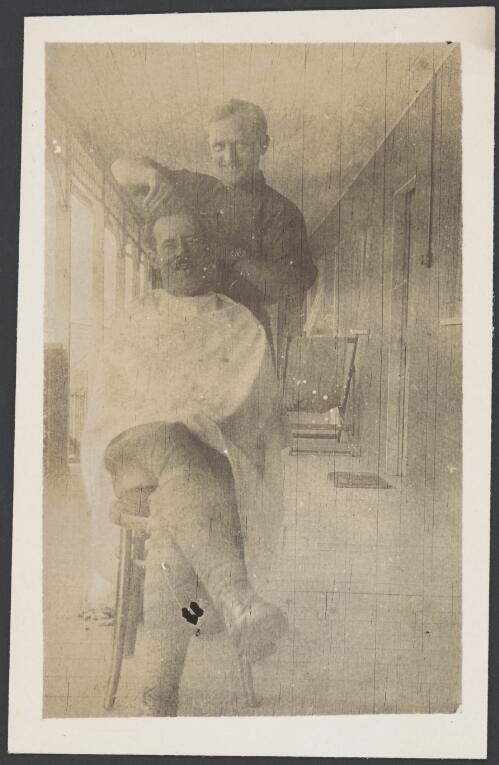 A barber giving a haircut, Holsworthy Internment Camp, Holsworthy, New South Wales, probably 1918 / S.C. Calderwood