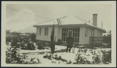 A man standing in front of a house on Torrens Street, Braddon, Canberra, probably 1928, 1