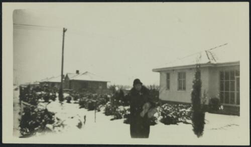 A man standing in front of a house on Torrens Street, Braddon, Canberra, probably 1928, 2