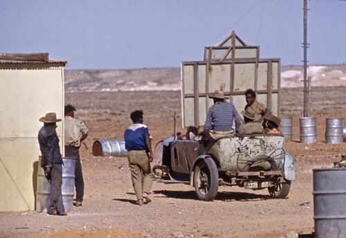 Aboriginal Australian people arriving in their car after driving from Oodnadatta, Coober Pedy, South Australia, approximately 1960 / Robin Smith
