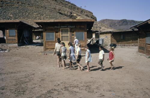 Children lined up and walking into school with their teacher, Northern Territory, approximately 1966 / Robin Smith