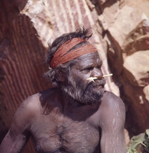 Aboriginal Australian man sitting at the entrance of a cave, Northern Territory?, approximately 1967 / Robin Smith
