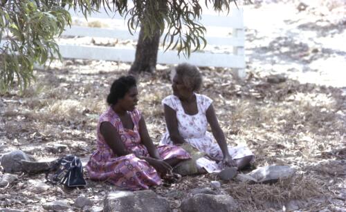 Two Torres Strait Islander women sitting in the shade of a tree, Thursday Island, Queensland, 1962 / Robin Smith
