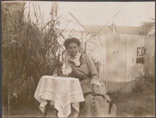 Portrait of a German woman seated at a table in a backyard, Parramatta, New South Wales / Carl Schiesser