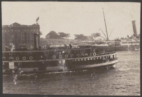 A steamboat in the habour sailing past buildings, Sydney, approximately 1914 / Carl Schiesser