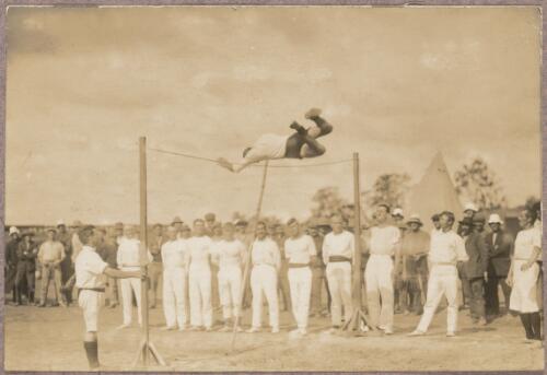 Gymnast performing on a high bar at the internment camp at Holsworthy, New South Wales, 1918 or 1919 / Carl Schiesser