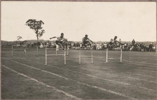 Three men hurdling on a track at the internment camp at Holsworthy, New South Wales, 1918 or 1919 / Carl Schiesser
