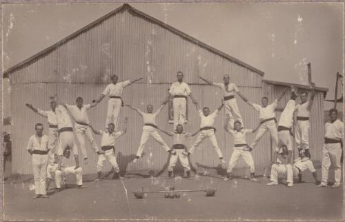 Acrobats performing outside a building at the internment camp at Holsworthy, New South Wales, 1918 or 1919 / Carl Schiesser