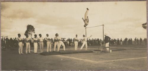 Gymnast dismounting from a high bar outside at the internment camp at Holsworthy, New South Wales, 1918 or 1919, 2 / Carl Schiesser