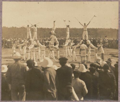 Acrobats performing in front of a crowd outside at the internment camp at Holsworthy, New South Wales, 1918 or 1919 / Carl Schiesser