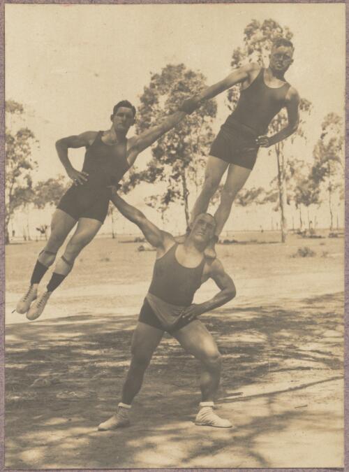 Three acrobats performing outside at the internment camp at Holsworthy, New South Wales, 1918 or 1919 / Carl Schiesser