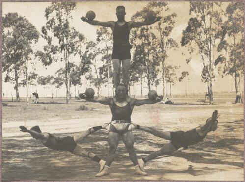 Four acrobats performing outside at the internment camp at Holsworthy, New South Wales, 1918 or 1919 / Carl Schiesser
