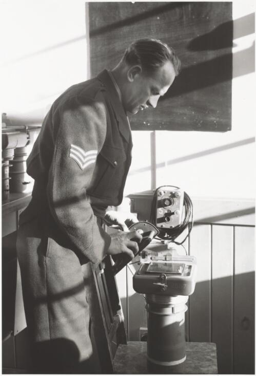 Sergeant Costa preparing an F24 aerial camera for installation in a mustang airplane, Fairbairn, Canberra, 1951  / Douglas Thompson