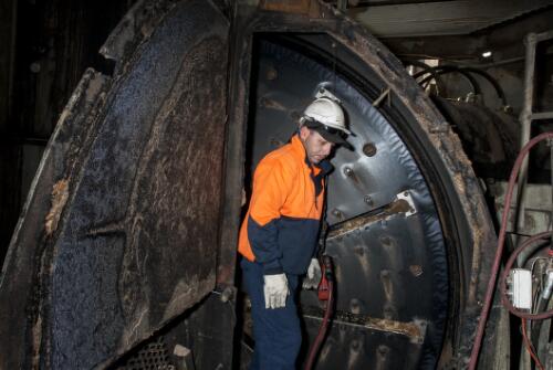 Wood chip industry worker, Nathan Boller, preparing to change the blades on a chipper machine at South East Fibre Exports chip mill, Eden, New South Wales, 2010 / Ruth Maddison