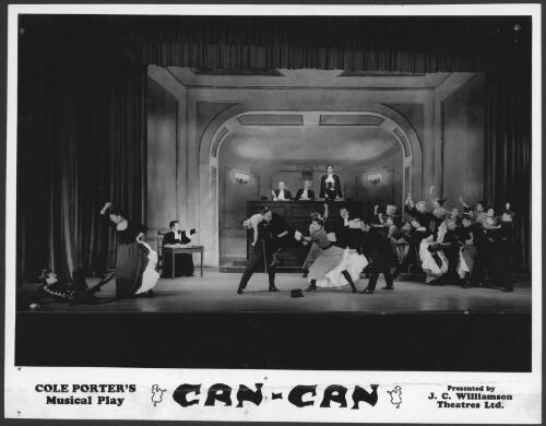Jill Perryman, second from left and William Newman, standing upstage at bench, in the J. C. Williamson production of Can Can, 1955-1958, Court scene with chorus & dancers [picture]